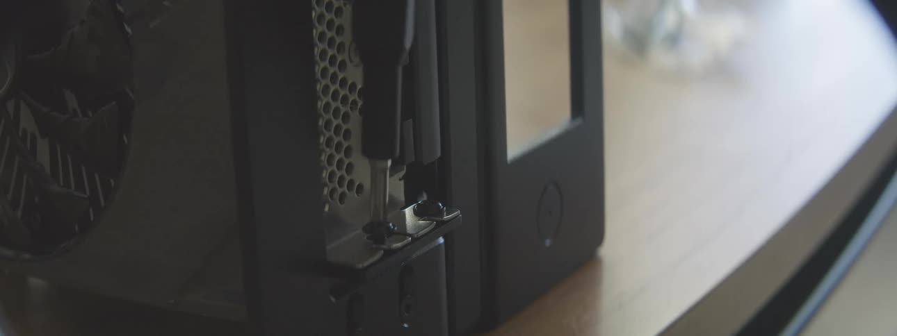 A person is using a screwdriver to build a computer