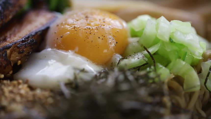 Close up of a plate of food with a roast pork and boiled egg