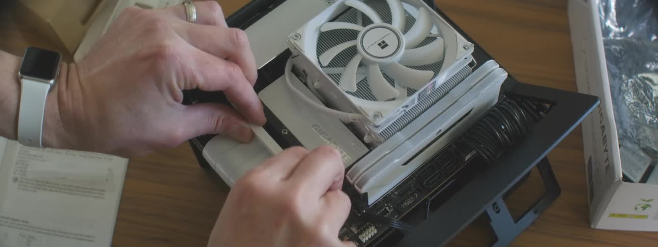 Person installs an ssd in a compact aircooled computer