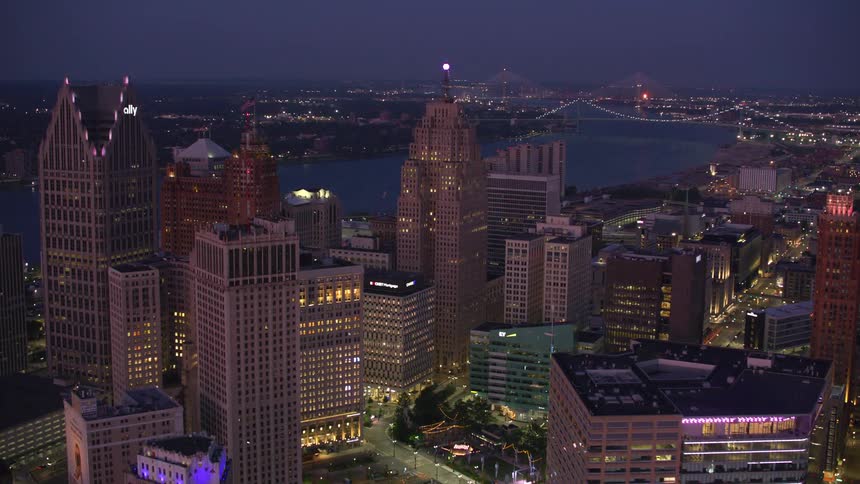 Aerial view of a metropolis illuminated at night and the seaside