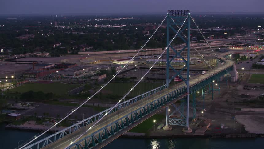 The sun is setting on the cable bridge
