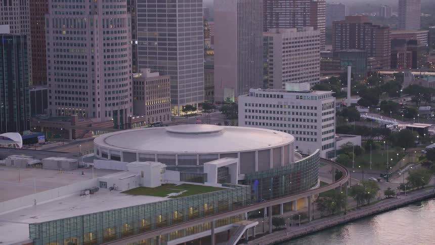Aerial view of an urban center with tall buildings and a large circular building standing out