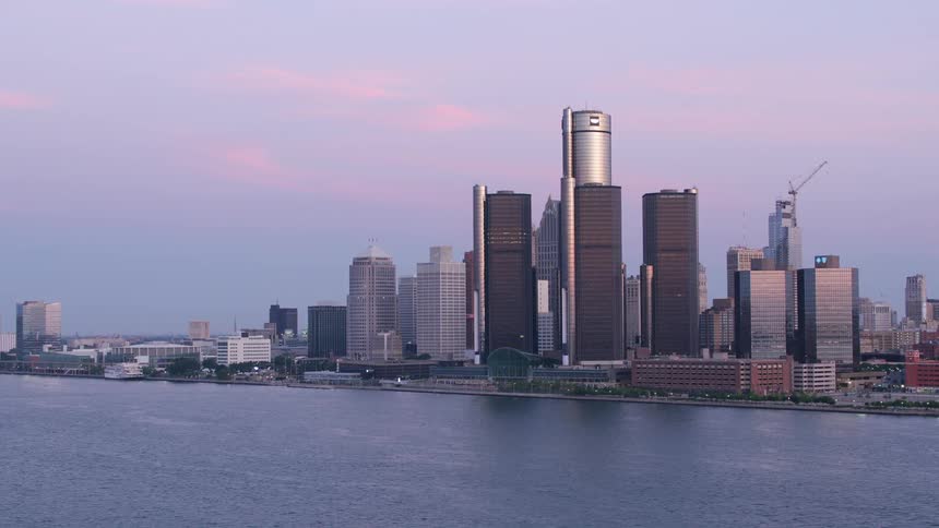 A view of a metropolitan city with huge skyscraper buildings facing a large body of water