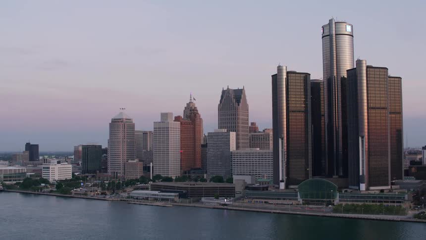 Skyscrapers reflect the dawn light along the riverbank