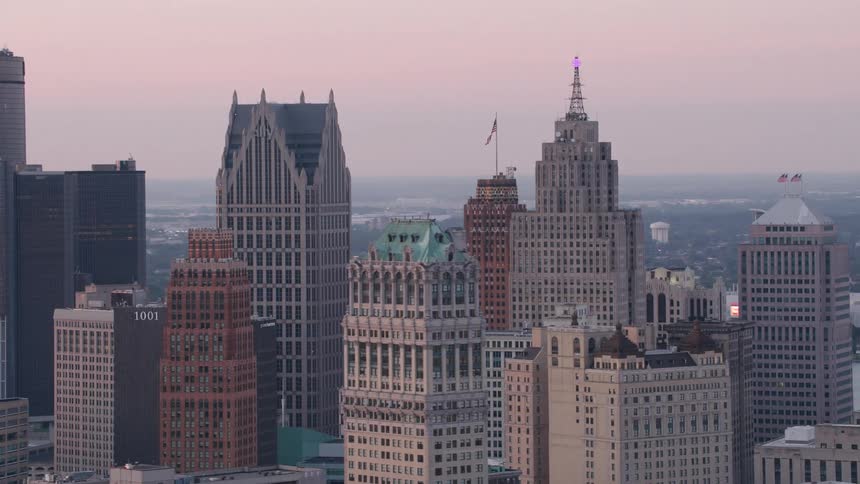 Skyscrapers of a city make up the horizon at dusk with the sky in soft tones