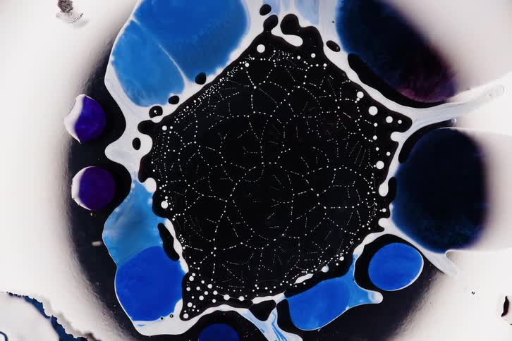 Extreme close up on a liquid in abstract suction of organic matter