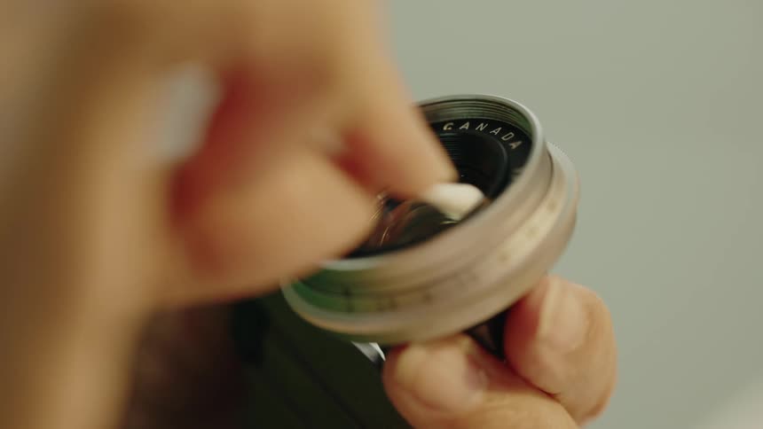 Cleaning camera lenses part with cotton swab