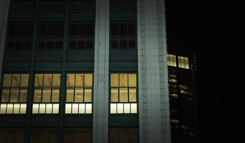 The lights are on in some of the building windows at night