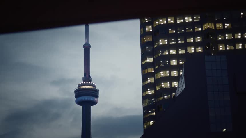 Cn tower next to skyscrapers
