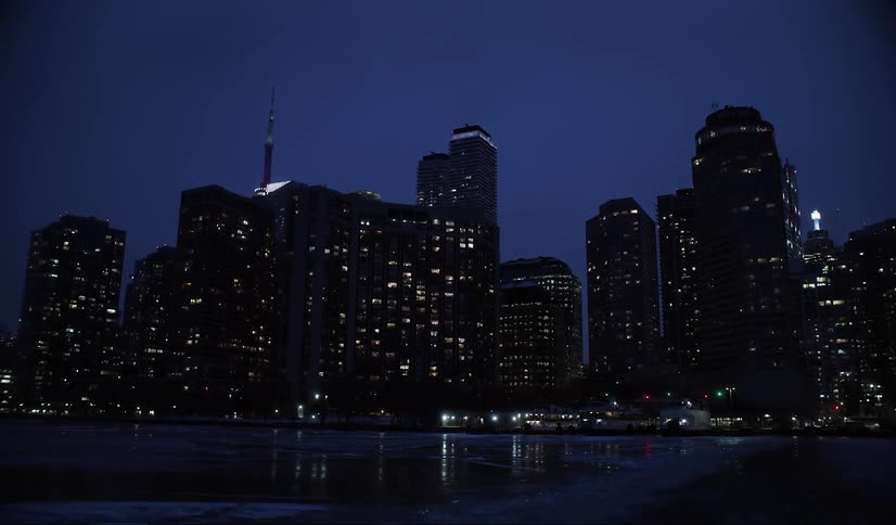 Panorama of a metropolis illuminated at night and the seaside