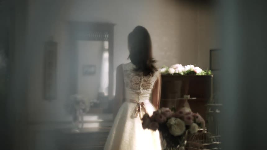 Woman in white dress facing a mirror