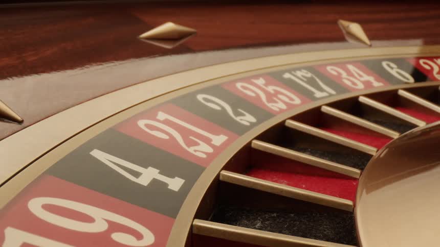 Roulette wheel with numbers spinning on a casino table