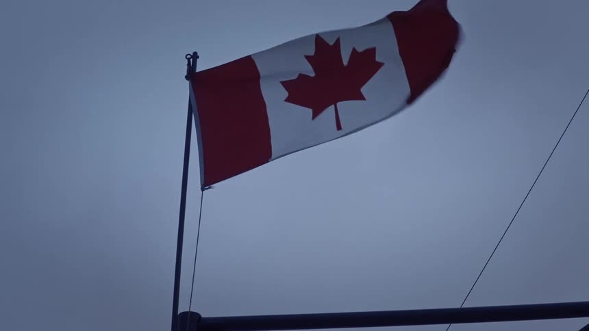 Canadian flag against a cloudy sky