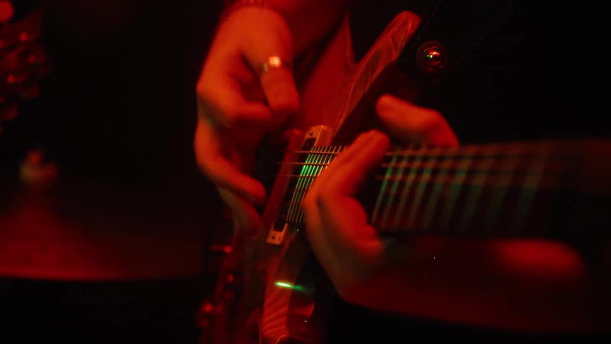 Lights flash on the guitar player performing