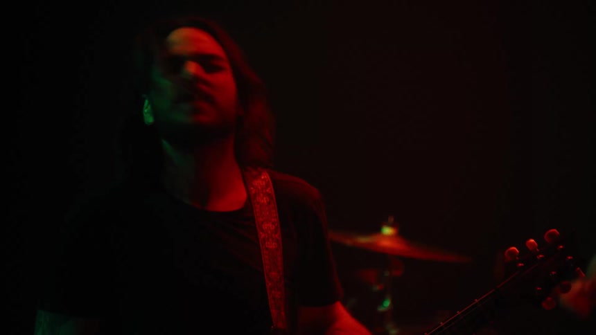 Guitarist playing vibrantly in a performance