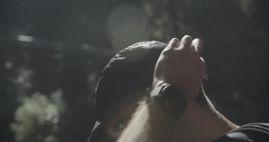 Man putting a wet cap on his head