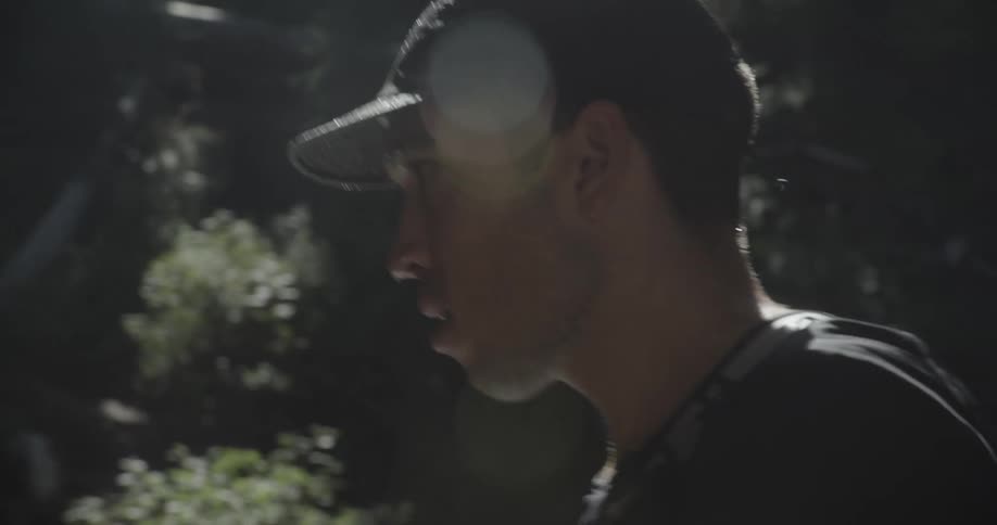 Man on a trail putting on a wet cap
