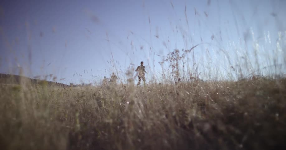 People run in line through the grass