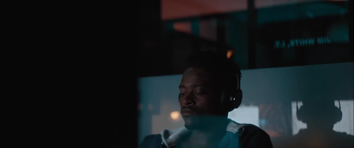 Man with headphones concentrating in an indoor space