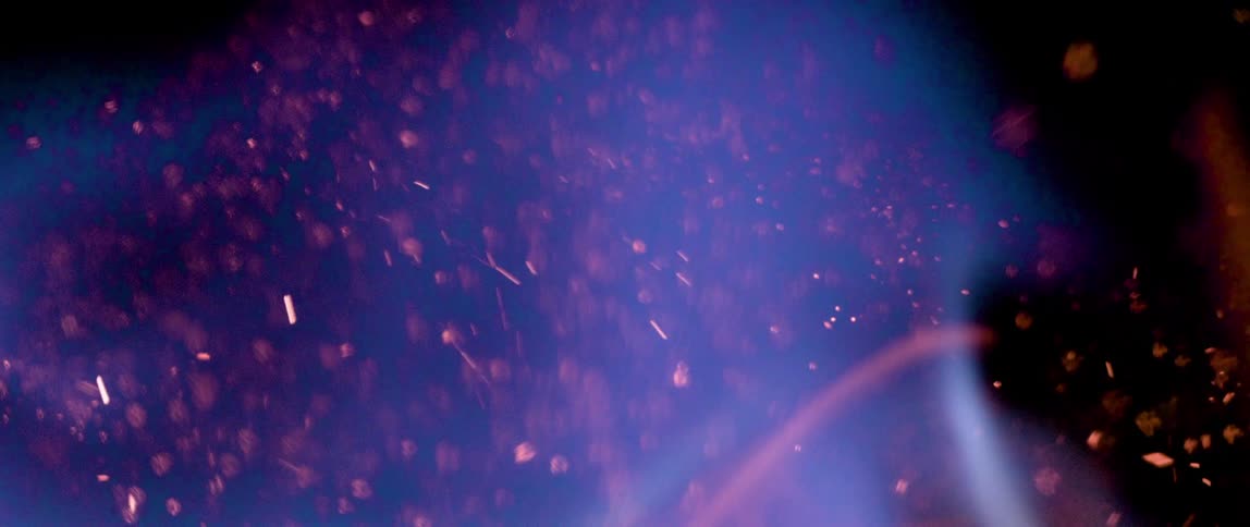 Blue and orange flames are intertwined with burning embers floating in and around the flames all set against a dark background creating a dynamic display of fire