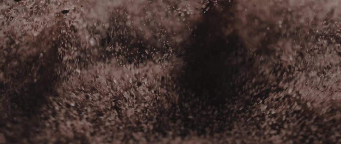 A large amount of sand is being expelled into the air repeatedly