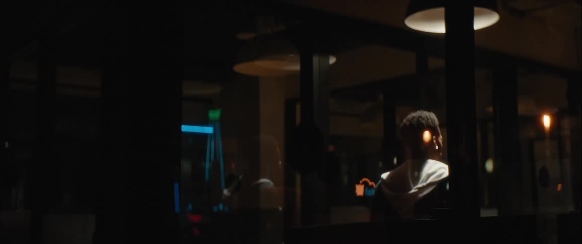 Person running down an office hallway at night