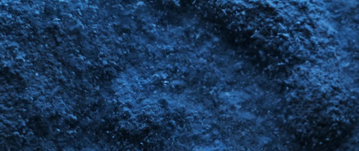 Abstract blue powder in motion