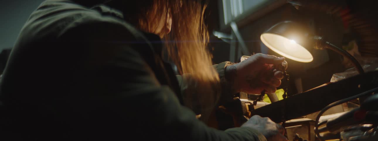 Pair of hands of a man adjusting a timing belt