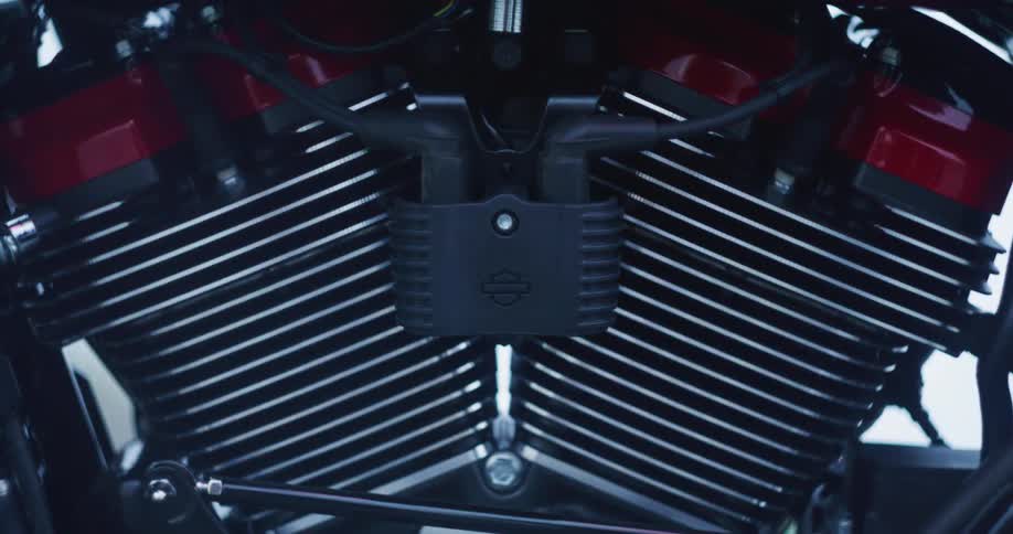 Red flashing light shines onto a machine part on a moving vehicle