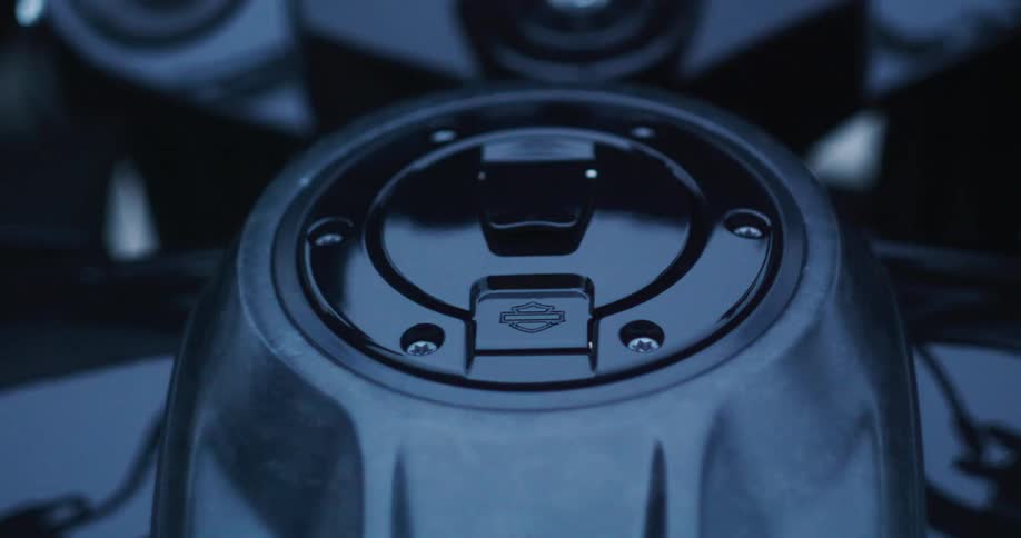 Closeup of the fuel tank cap of a moving harleydavidson motorcycle