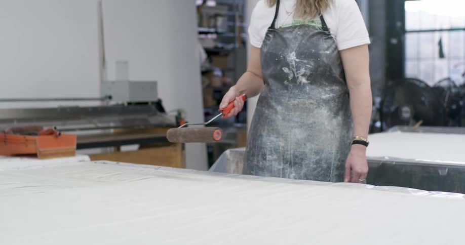 People are rolling over paper on a table
