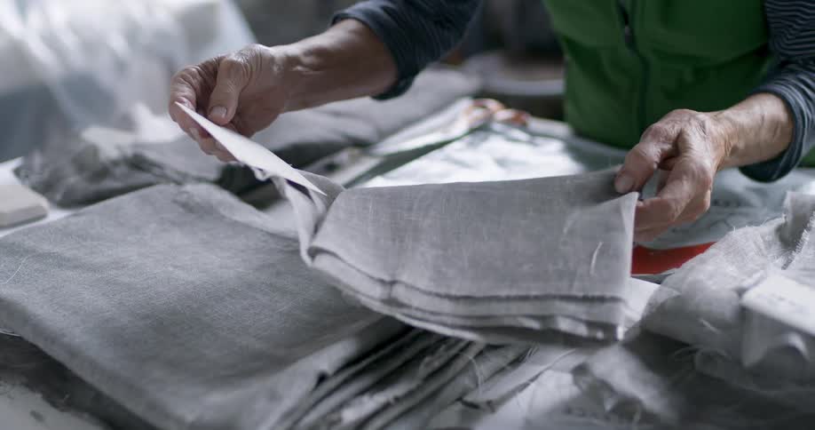 Person handles folded fabrics