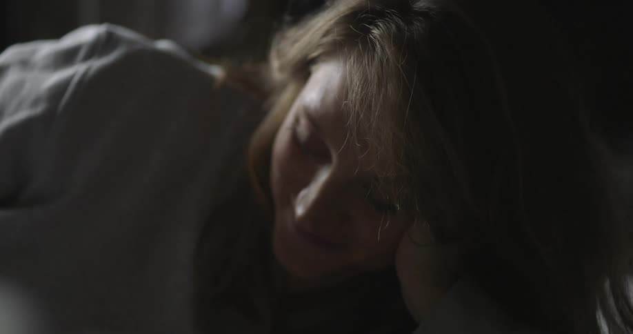 A person resting their head on their arm