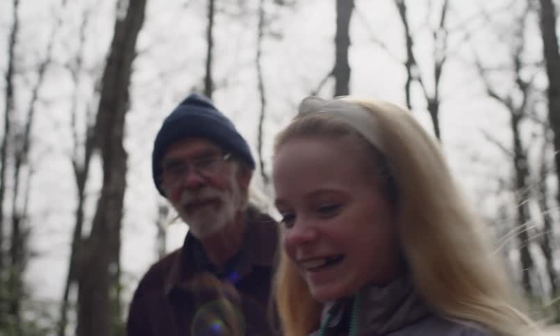 Grandpa walking on a trail with his two young grandchildren