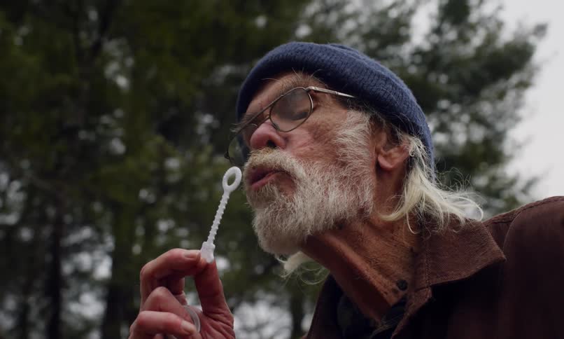 A clip of a man making bubbles
