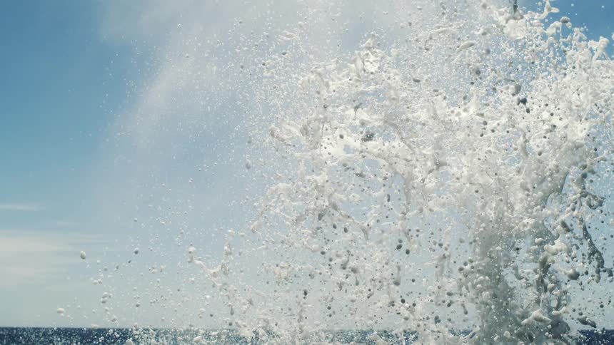 Several particles of water from an ocean wave going up and then falling down