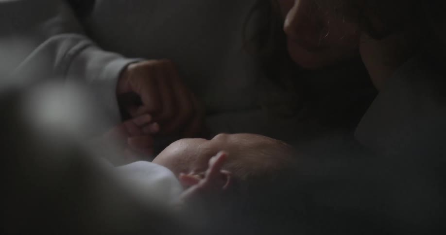 A man lays with a baby