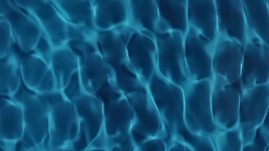Water Cymatics, Abstract blue light shifts across vibrating liquid