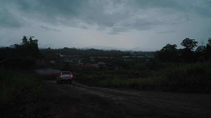 Silver car traveling on a dirt road