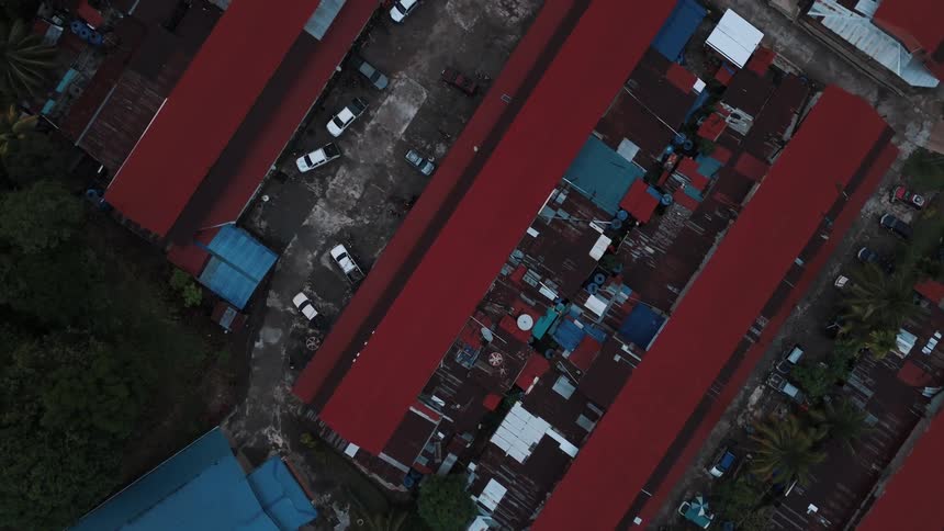Aerial view of a small precarious urban town surrounded by rivers in a natural region