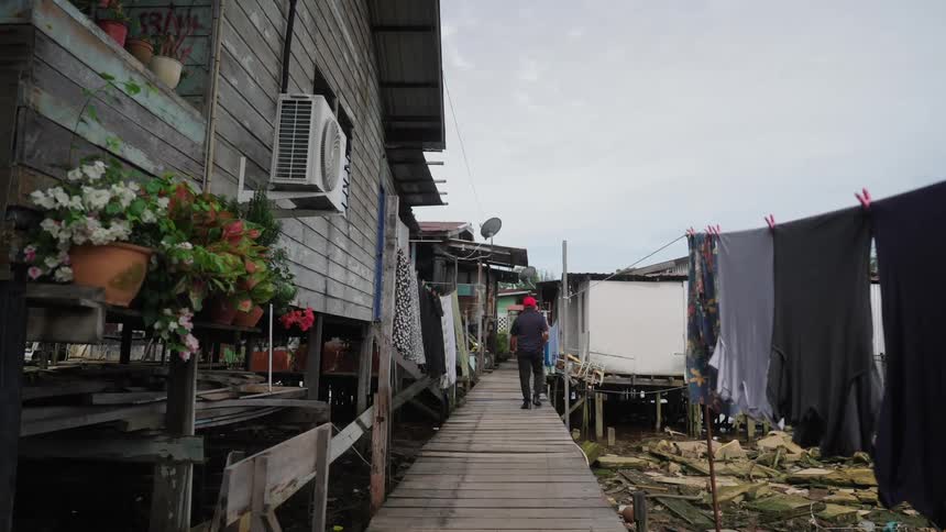 Man walking through a slum community during the day