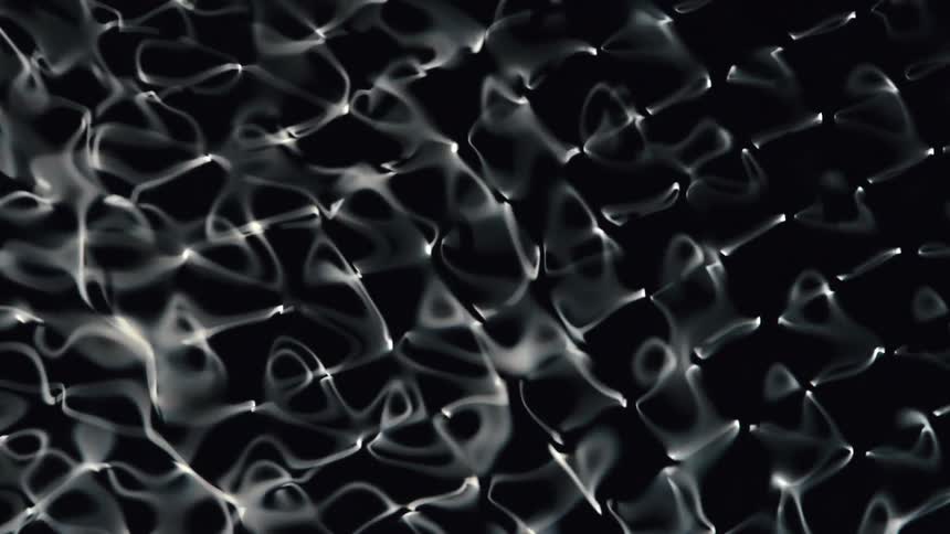 Water Cymatics, A complex pattern of interconnected vibrating wavy white lines in black liquid