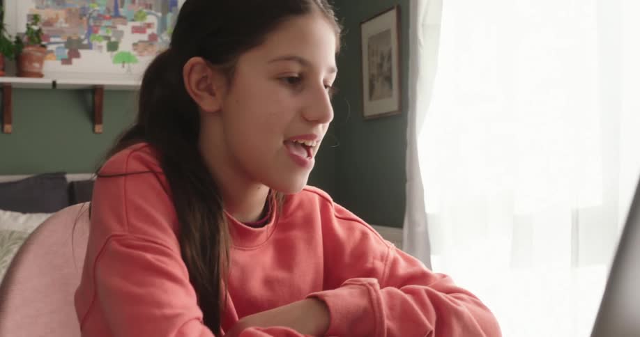 Girl talking in front of a laptop