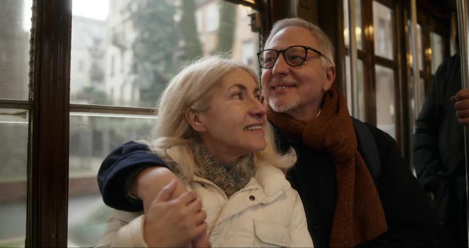 Couple hugging inside a moving public transport