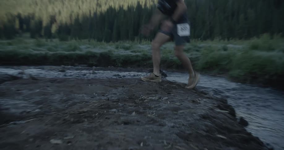 A clip of a teenager jumping over a river