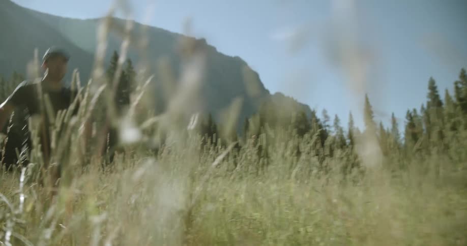 A field with tall grass and a person running quickly