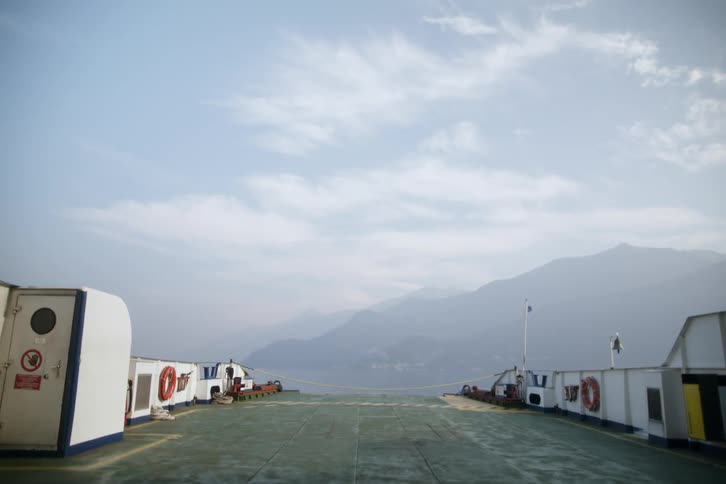 View of a long boat with mountains in the background