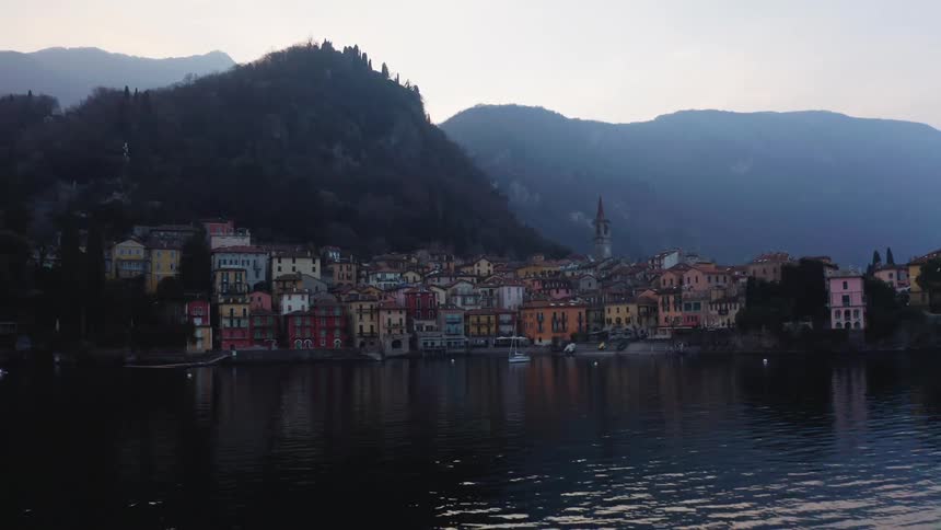Aerial panorama of a classic and colorful city at the foot of a mountain by the sea in a morning