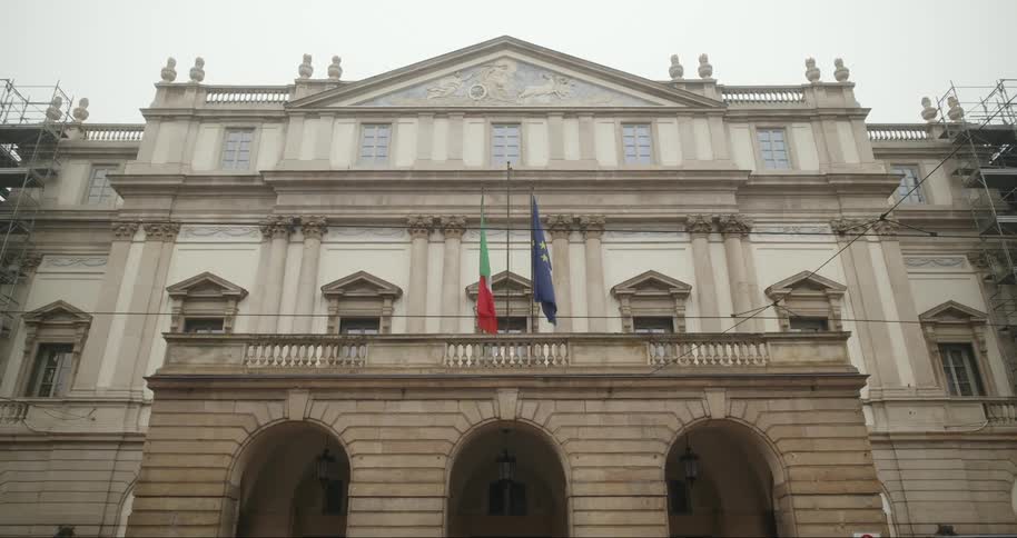 Facade of a classic building with flags in the center