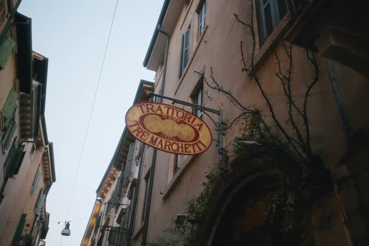 A shop sign hangs in the alley